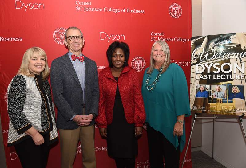 The groups stands in front of the Dyson banner