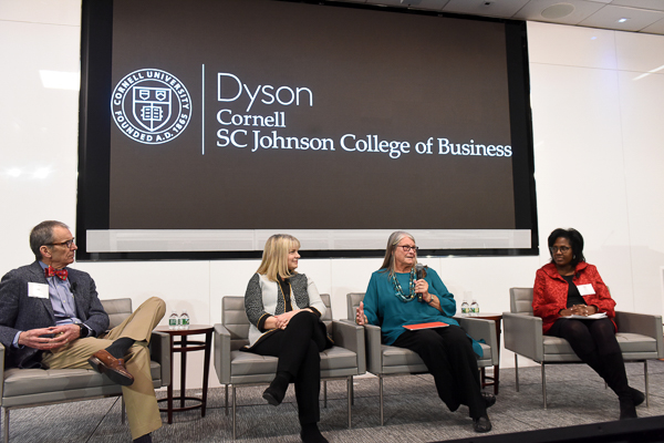Ed, Deb, Dale, and Lynn sitting on stage in a panel