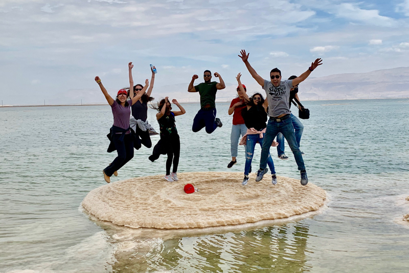 Jumping in the air over a small island in the Dead Sea