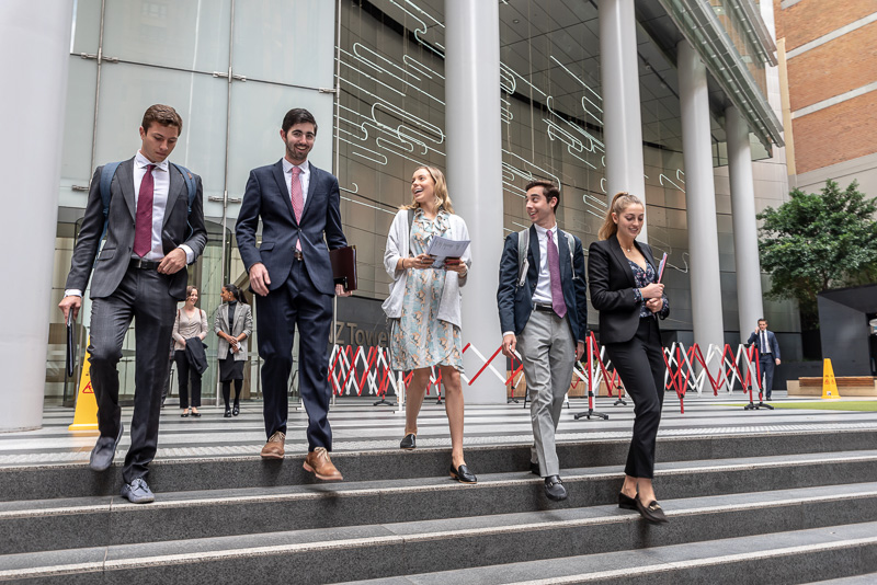 Students walk down stairs outside a building