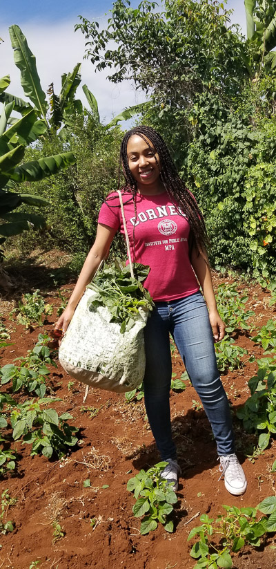 Naudia holding a bag in the farm