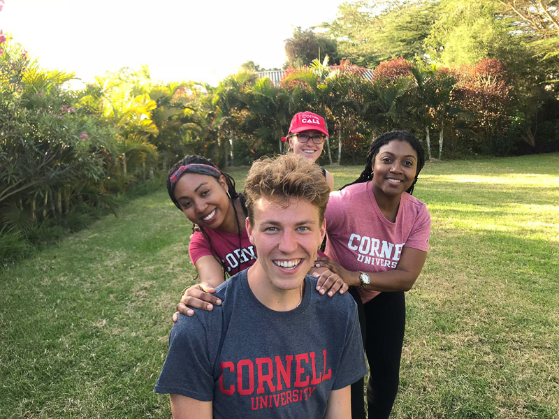 Students smiling for a photo in a field