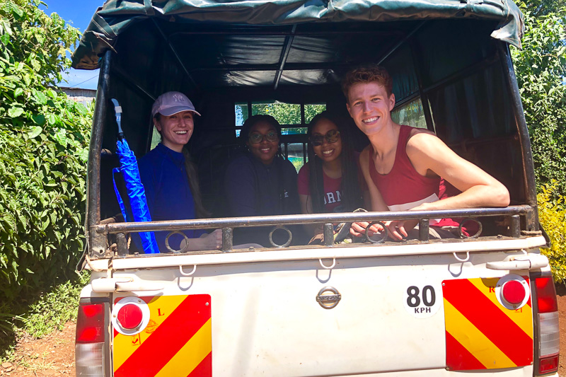 Student smiling in the back of a truck