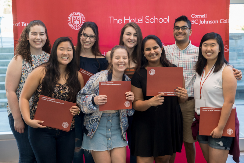 Group of eight students pose with their awards