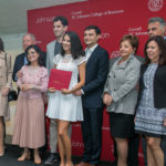 Guests and students pose for a photo