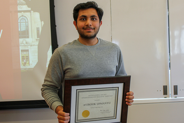 Avirook holding his award