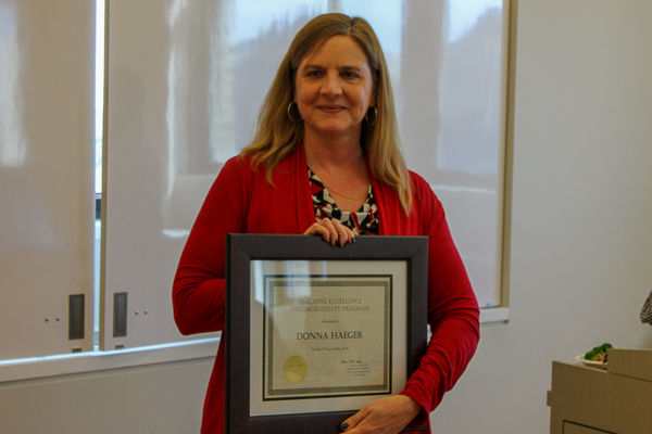 Donna Haeger holding her award