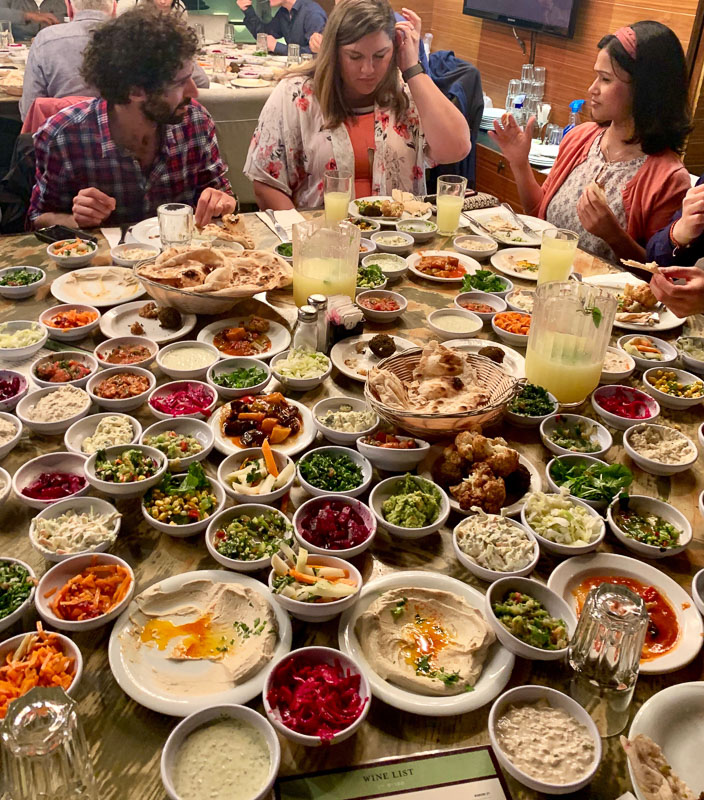 Table covered in bowls of food and samples