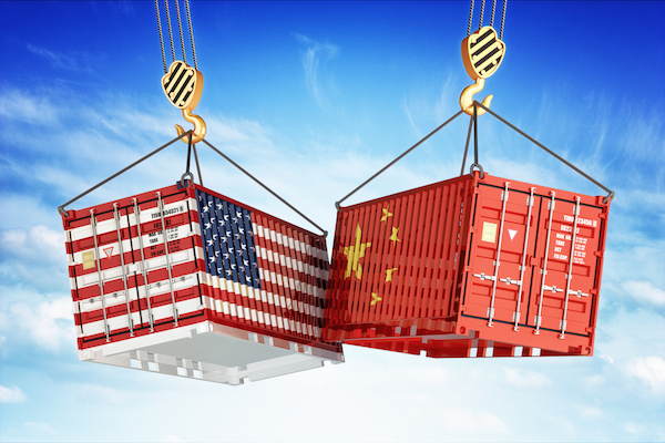 two containers with the american and chinese flags are being lifted by crane