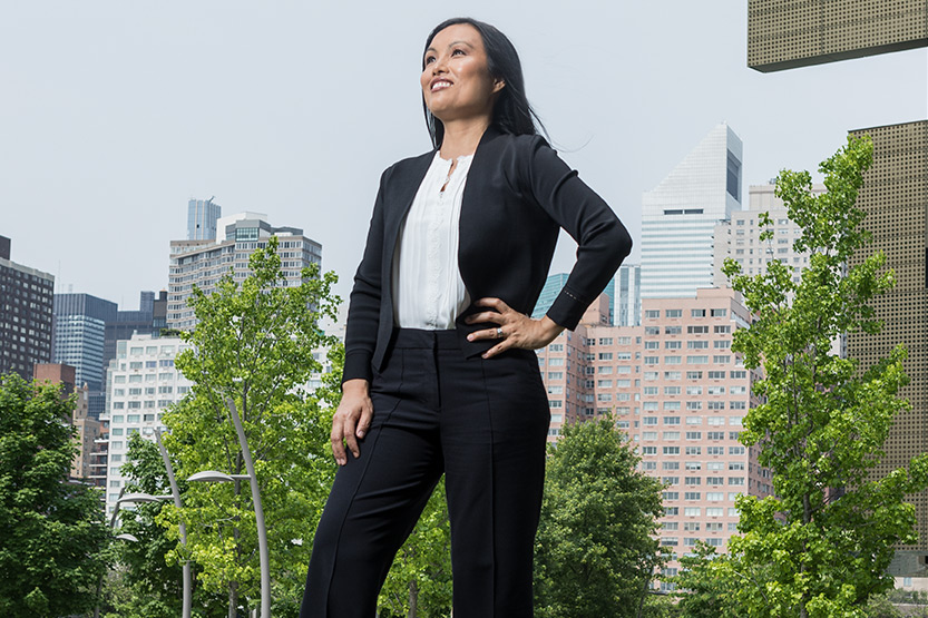 Maggie Chan Jones standing with a view of New York City behind her