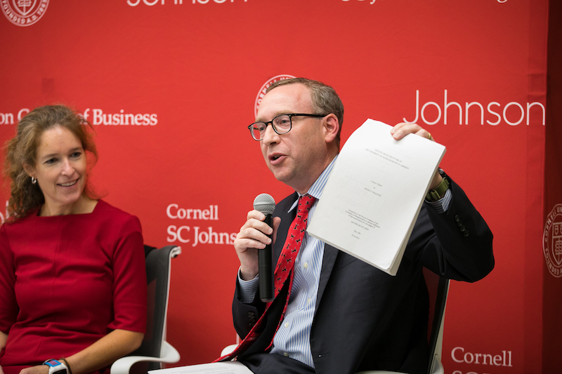 Dean Hallock holds up his paper