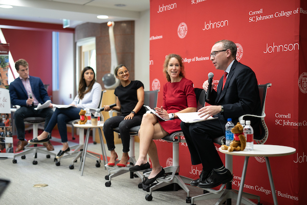 Five panel participants at the front of the room