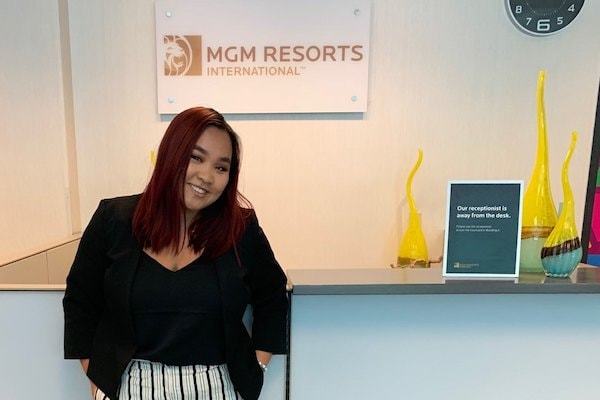 Quyen standing in front of the MGM Resorts logo