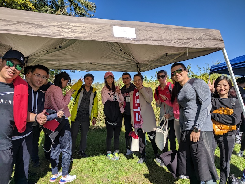 A smaller group poses for team photo under their tent 