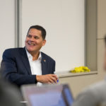 Reggie sits at the front of a classroom
