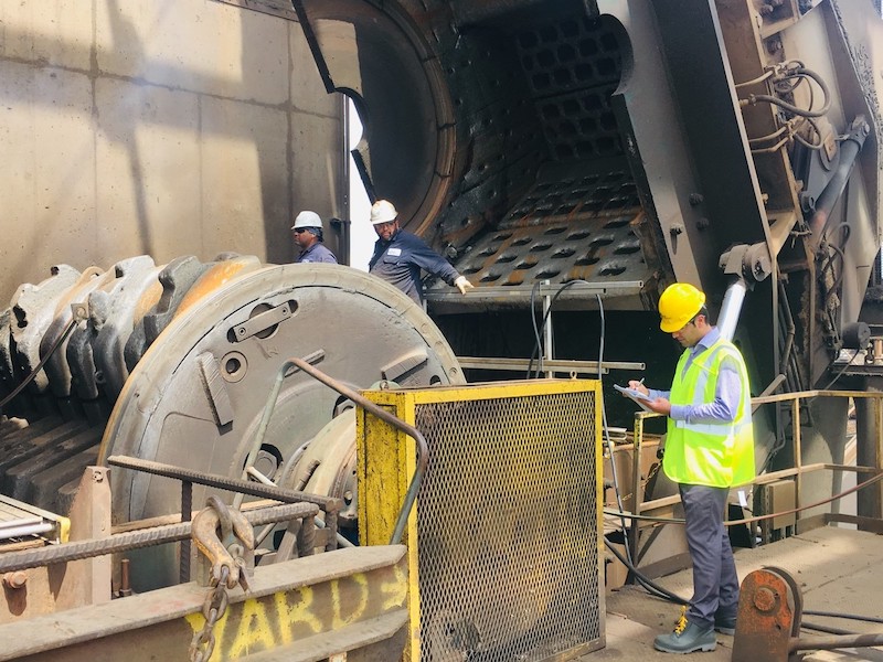 Nikunj standing by a large shredder