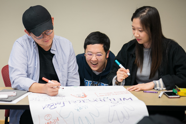 Three students work on a project in class