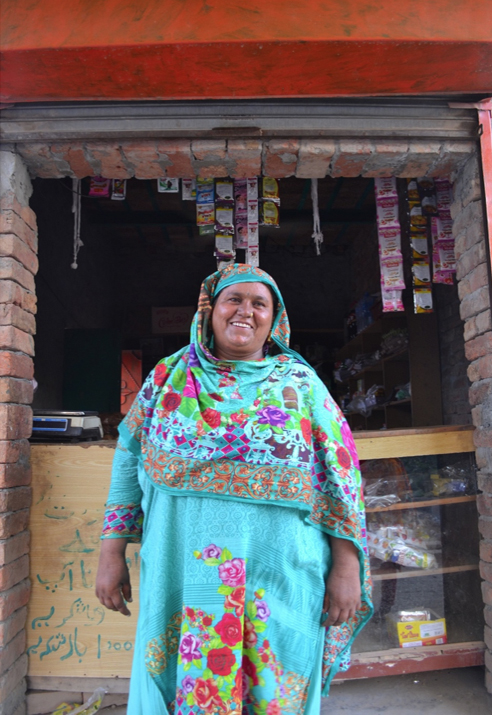 a community resource person stands in front of her store