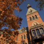 Sage Hall with autumn leaves and blue skies