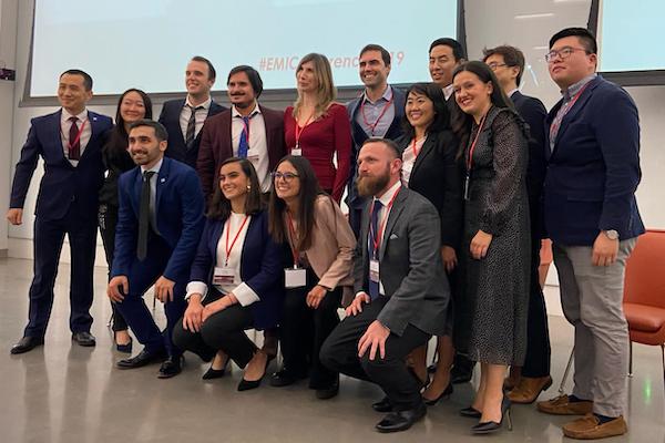 A team poses for a photo at the front of the conference space