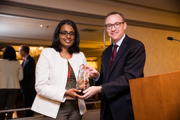 Lakshmi is presented with an award from Dean Hallock