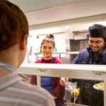 A student serving a meal