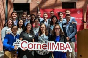 Park Fellows pose for a photo with a #CornellMBA sign