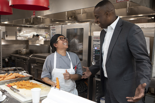 Hotel general manager talks with staff member