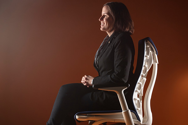 Christina Keller in profile, sitting in a Herman Miller chair