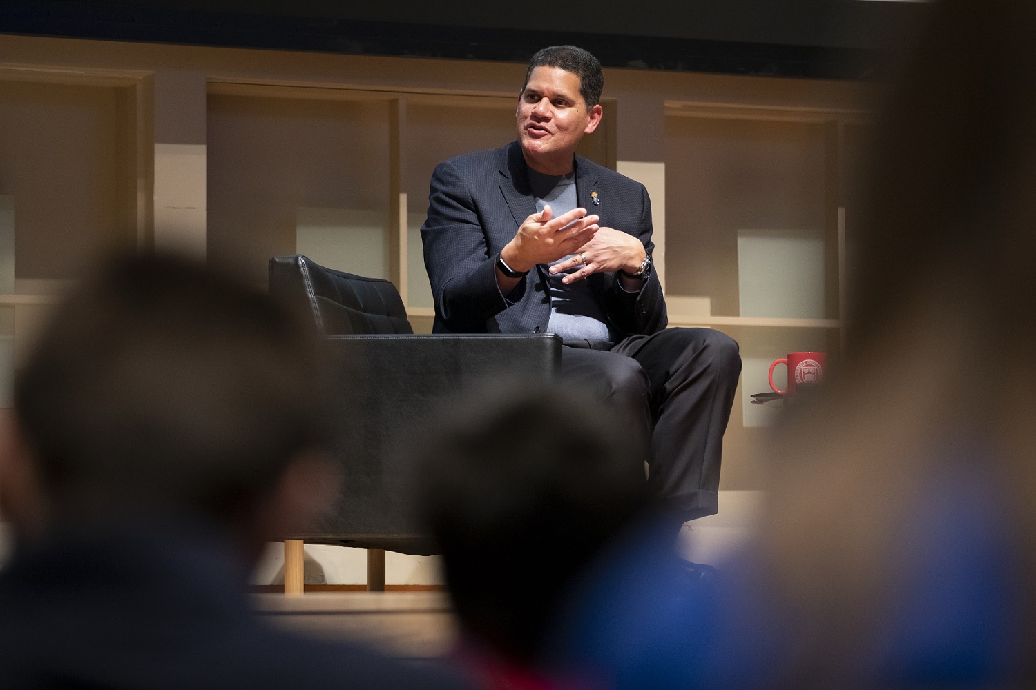 Reggie leads a discussion from on stage