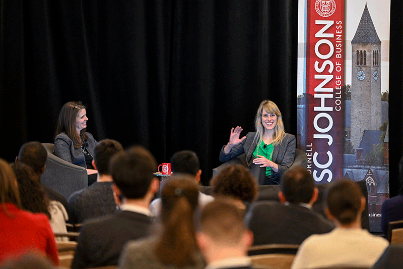 Laura Georgianna and Jessica Rolph in chairs on stage with the audience in the foreground