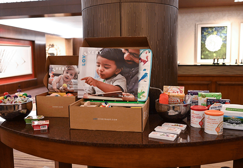 Products from the brands Jessica Rolph cofounded, Happy Family and Lovevery, displayed on a table in the receptioin area at the at the InterContinental Times Square