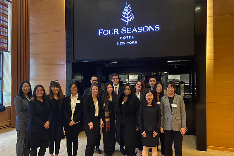 MMH students stand in front of Four Seasons Hotel entrance.