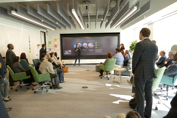 Faculty listen to a presentation at Deloitte