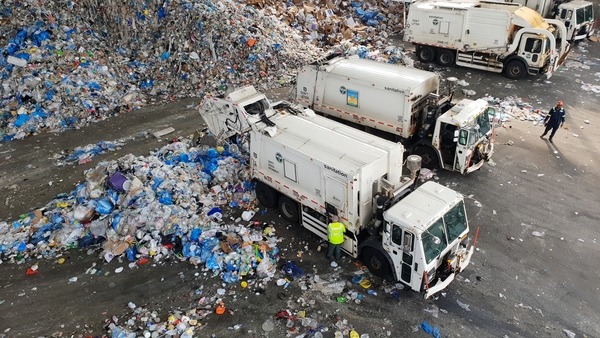 Trucks dumping piles of recycling