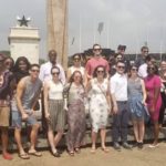 Students stand outside in the sun in Ghana