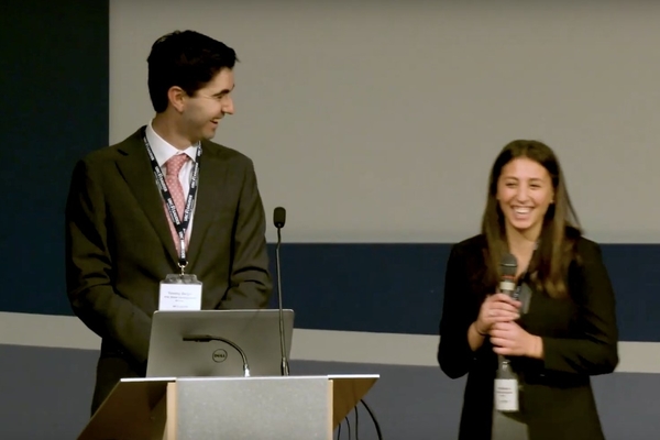 Tori Weissman, Carol Wang, and Tim Bergin stand with judge on stage.