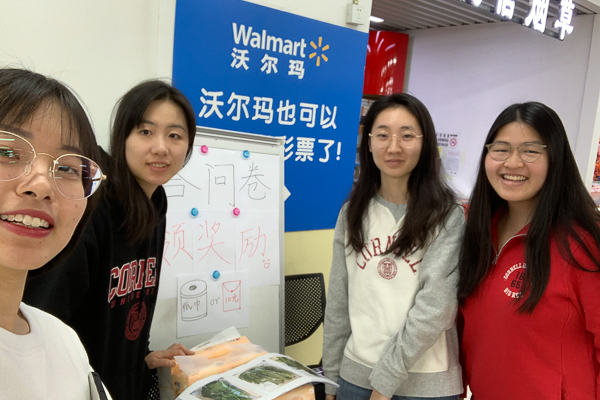 Students standing at a Walmart kiosk