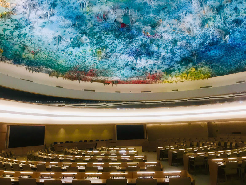 A gathering hall with bright, colorful ceiling art