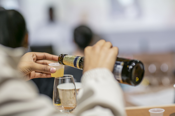 A student pours a measured sample of beer in Miller's class.