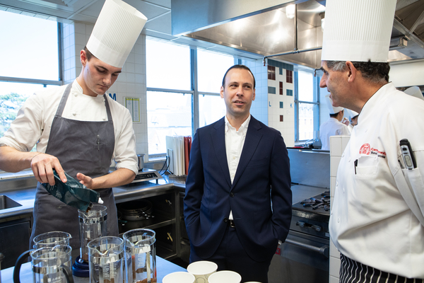 Jacob Chestnut talks with chef-instructor Anthony Vesco while SHA student Sean Koenig-Zanoff '21 prepares the coffee for a tasting session in The Business of Coffee.