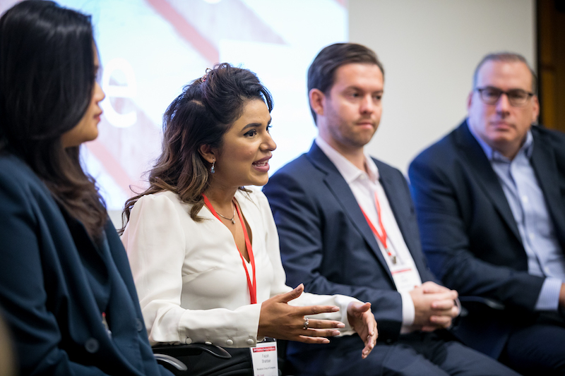 A panel of four people talking