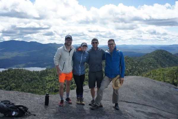 Four students standing at the top of a mountain