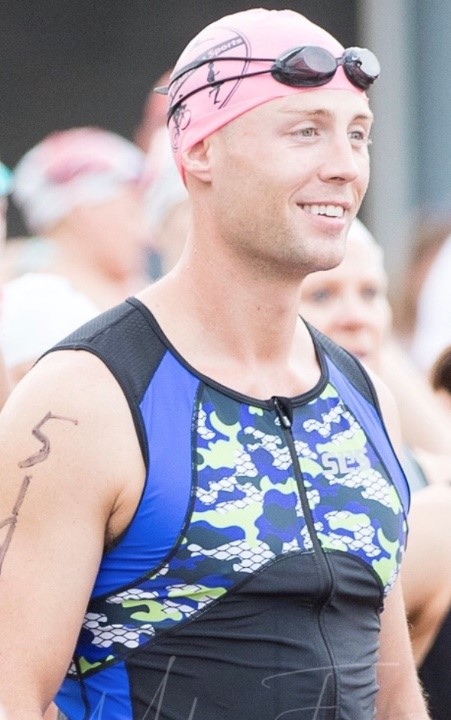 Greg stands in a swim cap among a crowd