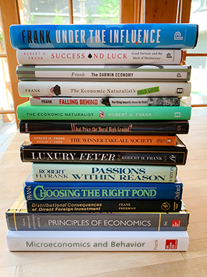 stack of books written by Robert H. Frank