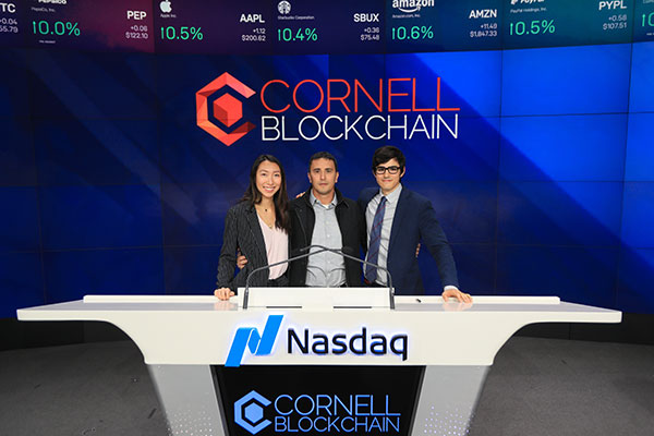 photos of (left to right) Lynette Ban ’19, Emin Gün Sirer, associate professor of computer science, and Joe Ferrara ’19 standing behind the podium at Nasdaq