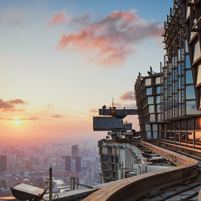 Glass building and sunset over city