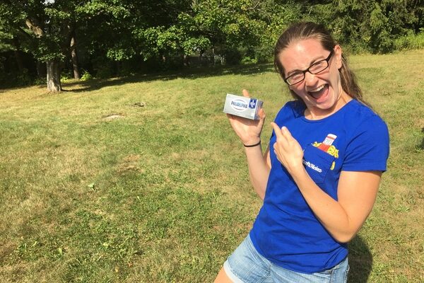 A picture of Kaitlyn Briggs holding a box of Philadelphia Cream Cheese