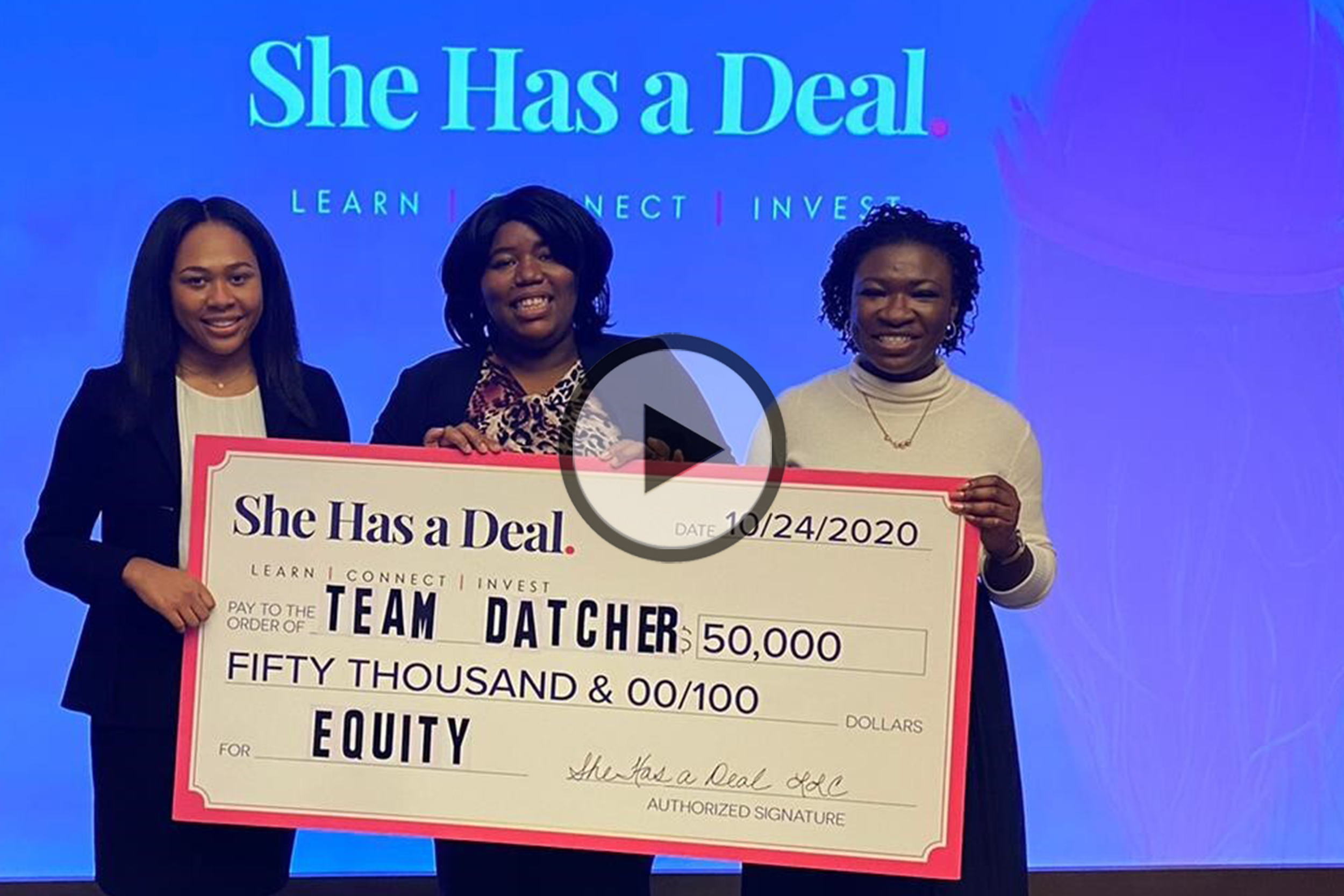 Kristen Collins, Lera Covington, and Joanne Angbazo holding their prize for winning She Has a Deal: a check for $50,000 in equity