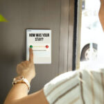 Photo of a person taking a survey about their hotel stay.